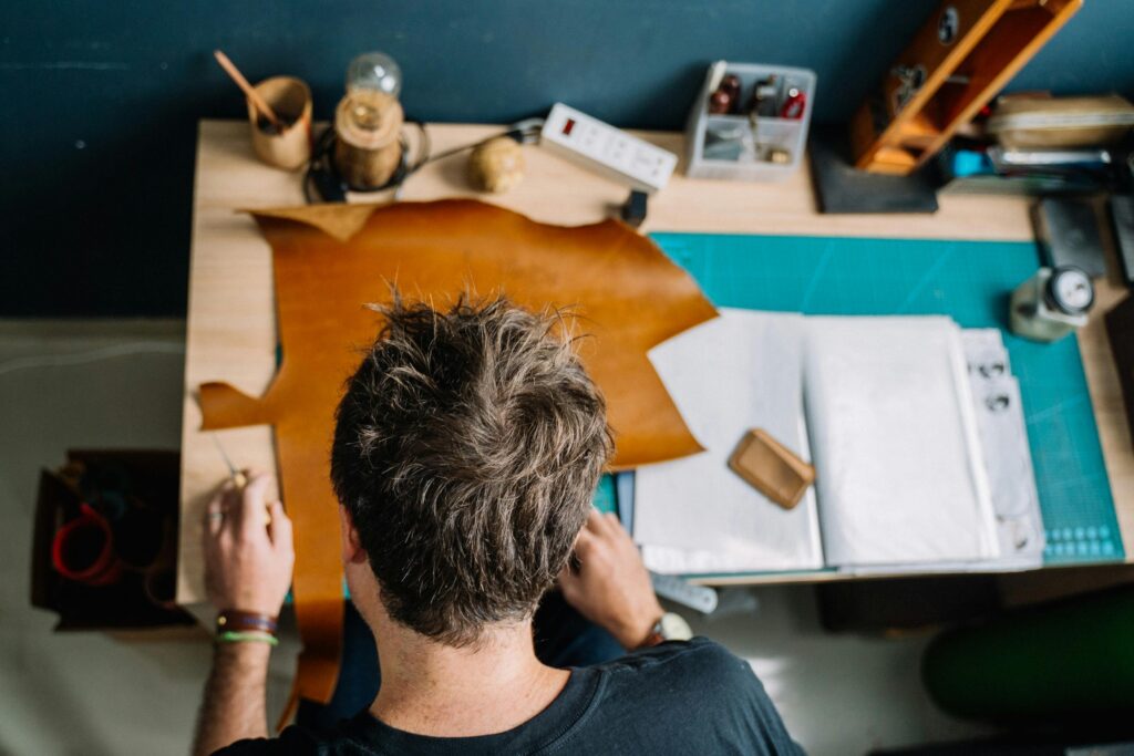 A Man Cutting Leather